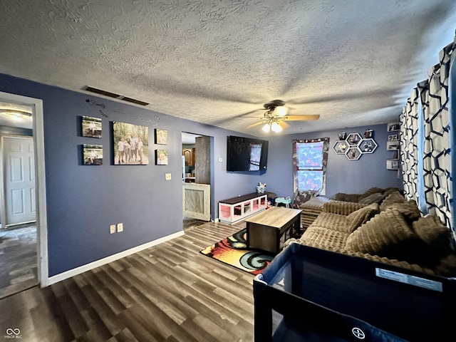 living room with hardwood / wood-style flooring, a textured ceiling, and ceiling fan