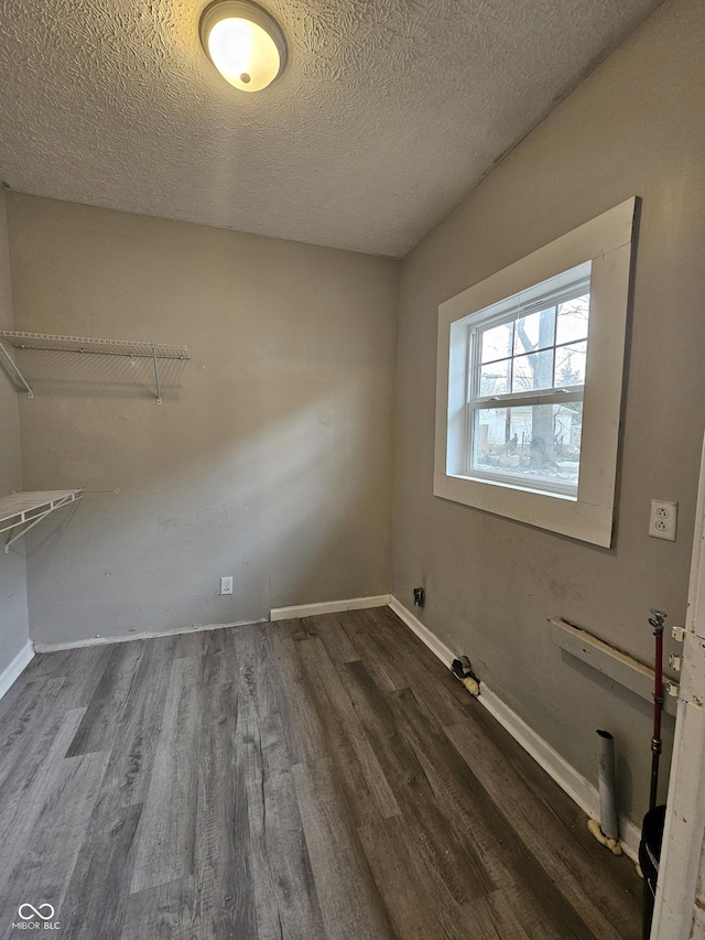 interior space with dark hardwood / wood-style floors and a textured ceiling