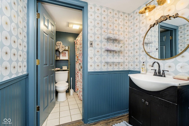 bathroom with vanity, tile patterned floors, and toilet