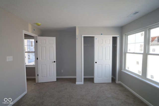 unfurnished bedroom featuring multiple windows and baseboards