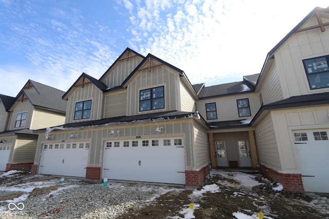 view of front of house with brick siding, board and batten siding, and an attached garage