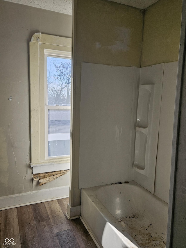 bathroom featuring hardwood / wood-style flooring and a tub