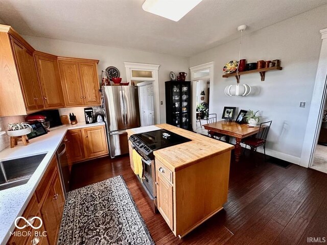 12801 E Edgewater Rd, Albany, IN 47320 - kitchen featuring appliances with stainless steel finishes, wood counters, dark wood-type flooring, a kitchen island, and a sink
