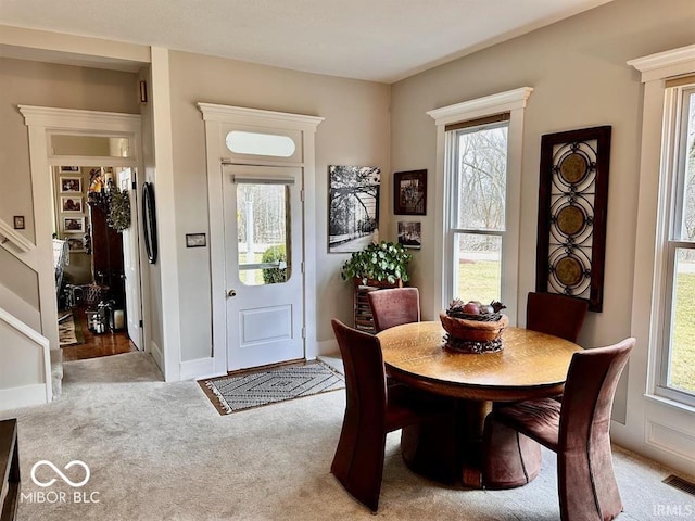 12801 E Edgewater Rd, Albany, IN 47320 - dining room with light colored carpet, healthy amount of natural light, and baseboards
