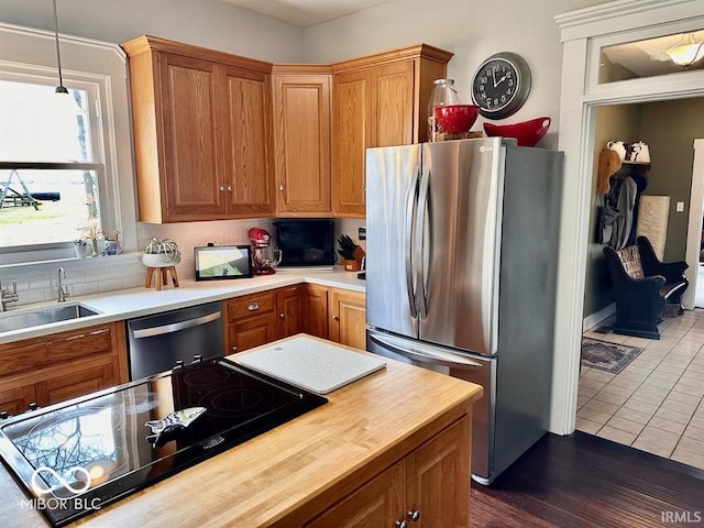 12801 E Edgewater Rd, Albany, IN 47320 - kitchen featuring stainless steel appliances, a sink, butcher block countertops, tasteful backsplash, and dark tile patterned floors