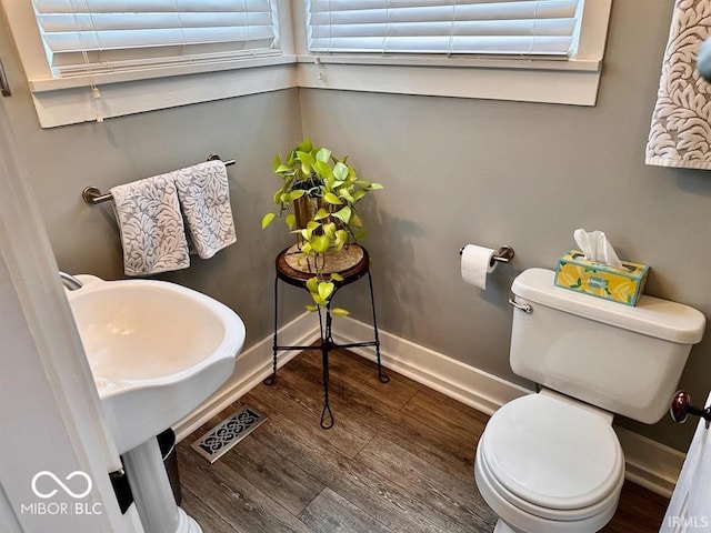 12801 E Edgewater Rd, Albany, IN 47320 - bathroom featuring toilet, wood finished floors, and baseboards