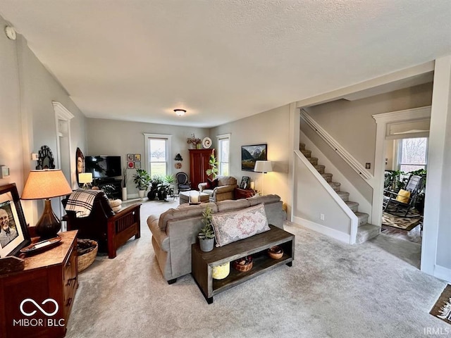 12801 E Edgewater Rd, Albany, IN 47320 - living area featuring stairs, healthy amount of natural light, light carpet, and baseboards