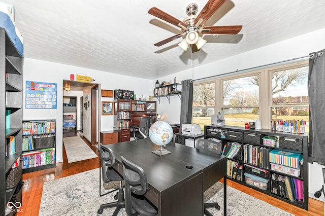 office with ceiling fan, hardwood / wood-style floors, and a textured ceiling