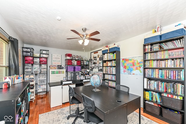 office featuring ceiling fan, hardwood / wood-style floors, and a textured ceiling