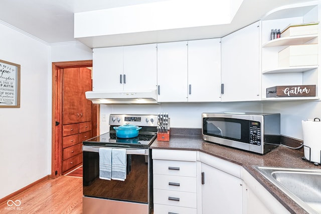 kitchen featuring white cabinetry, stainless steel appliances, crown molding, and light hardwood / wood-style floors