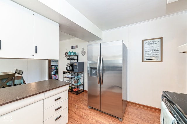 kitchen featuring white cabinetry, stainless steel fridge with ice dispenser, and light hardwood / wood-style flooring