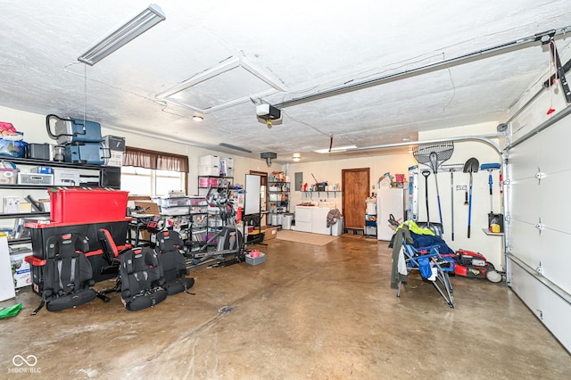 garage featuring a garage door opener and washer and dryer