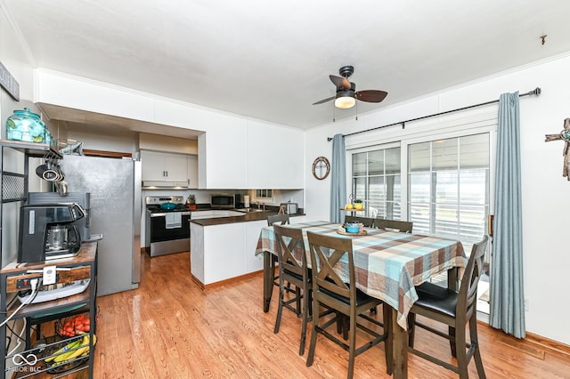 dining room with ceiling fan and light wood-type flooring