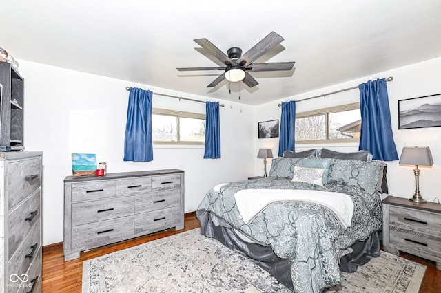 bedroom with wood-type flooring and ceiling fan