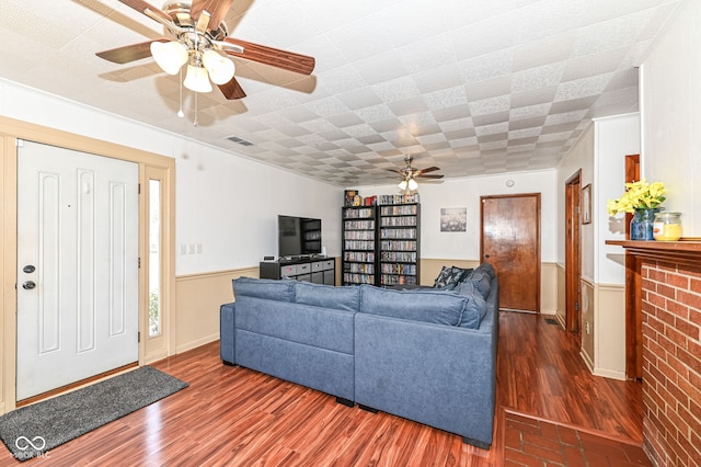 living room featuring dark hardwood / wood-style floors and ceiling fan