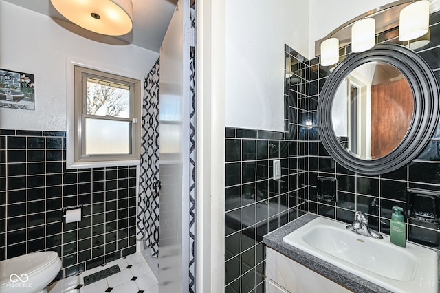 bathroom with a shower with curtain, vanity, toilet, and tile walls