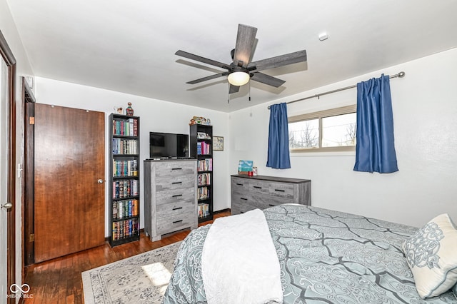 bedroom with dark hardwood / wood-style flooring and ceiling fan