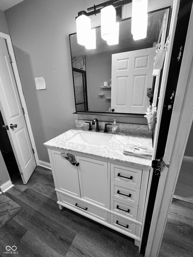 bathroom featuring hardwood / wood-style flooring and vanity