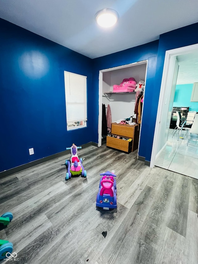 bedroom with hardwood / wood-style flooring and a closet