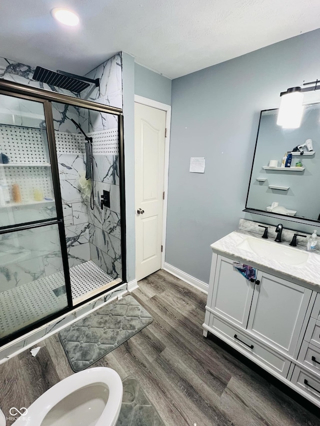 bathroom with vanity, hardwood / wood-style floors, and walk in shower