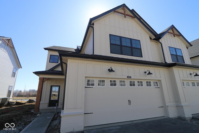 view of front of house featuring concrete driveway, an attached garage, and board and batten siding