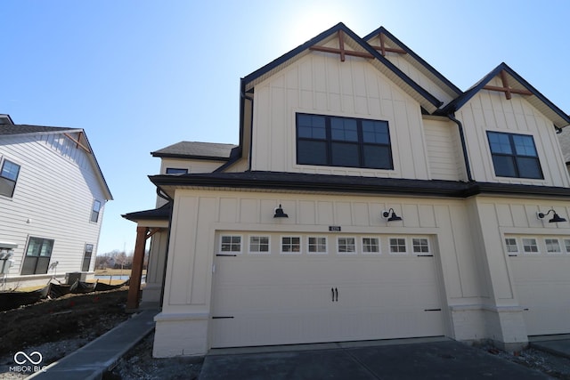 view of front of house featuring board and batten siding, concrete driveway, and an attached garage