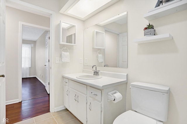 bathroom featuring vanity, toilet, and tile patterned flooring