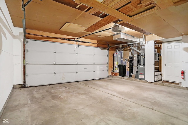 garage featuring a garage door opener, gas water heater, and heating unit