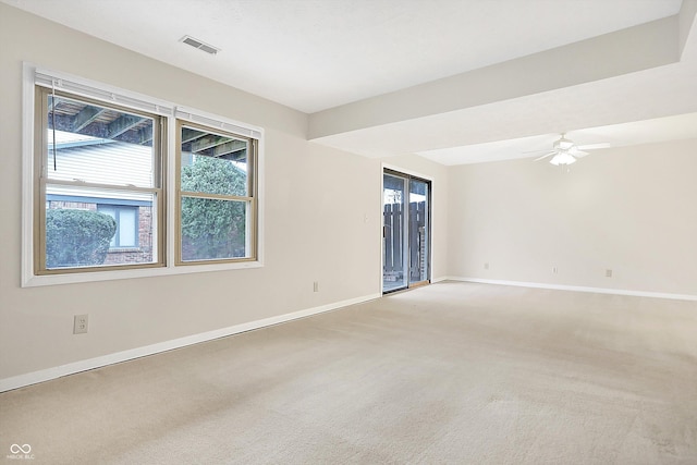 carpeted spare room featuring ceiling fan