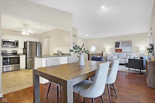 dining room featuring vaulted ceiling, dark hardwood / wood-style floors, and ceiling fan