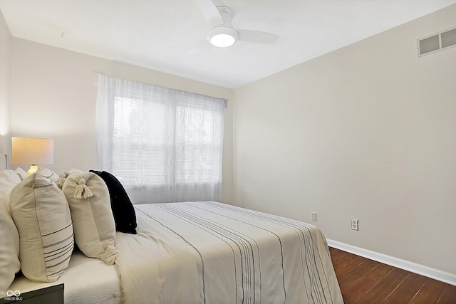 bedroom with ceiling fan and dark hardwood / wood-style flooring