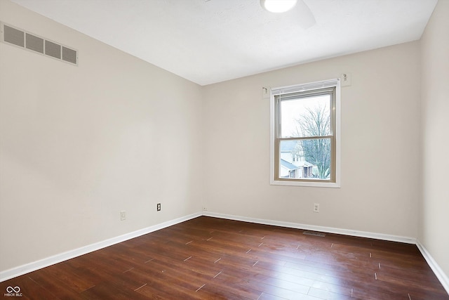 unfurnished room featuring dark wood-type flooring and ceiling fan