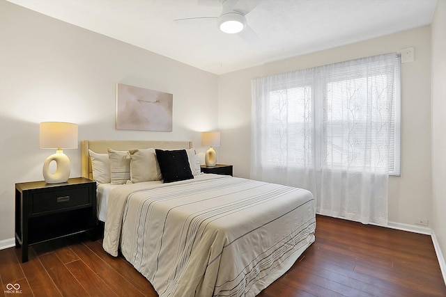 bedroom with ceiling fan and dark hardwood / wood-style floors