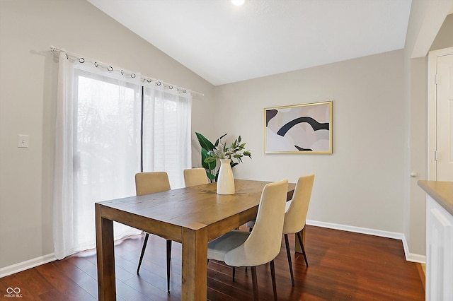 dining space featuring lofted ceiling and dark hardwood / wood-style floors