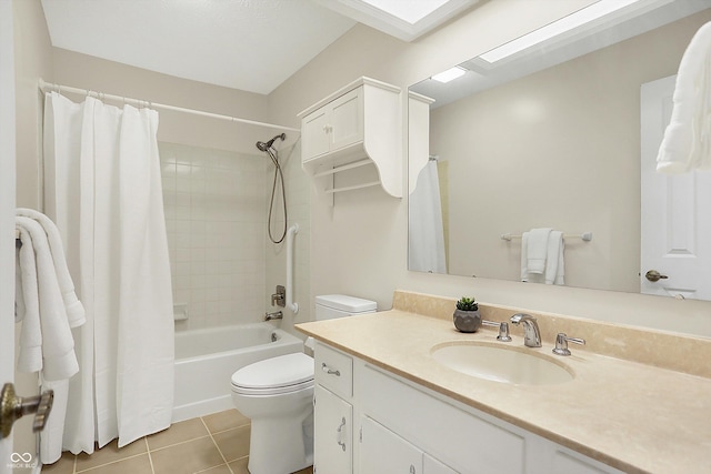 full bathroom featuring a skylight, tile patterned flooring, vanity, shower / tub combo, and toilet