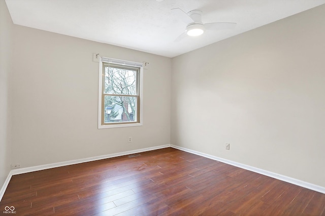 unfurnished room featuring dark wood-type flooring and ceiling fan