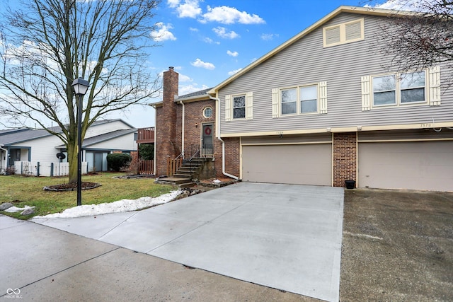 view of front of home with a garage and a front lawn