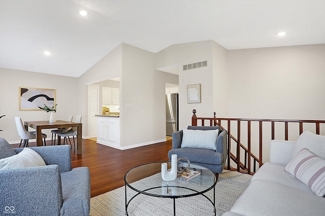 living room featuring dark hardwood / wood-style flooring and vaulted ceiling