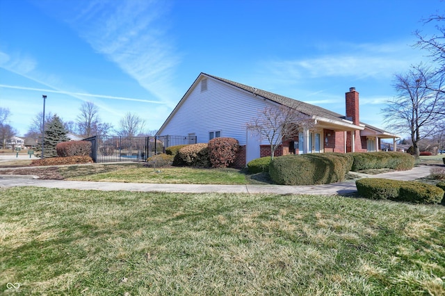 view of side of home with a lawn