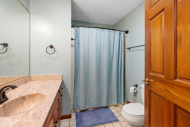 bathroom featuring curtained shower, vanity, toilet, and tile patterned floors