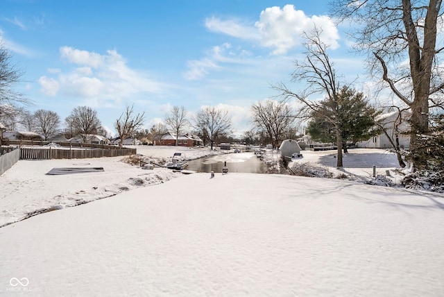 yard layered in snow with fence