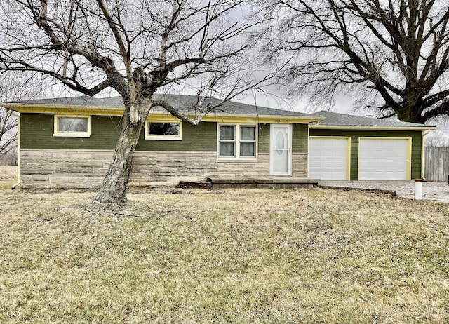 ranch-style home featuring a garage and a front lawn