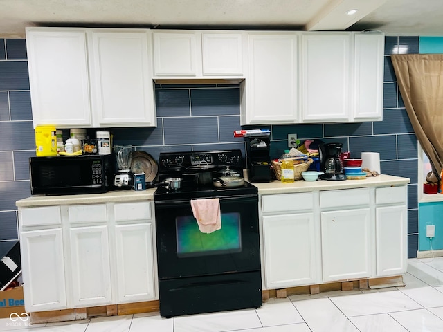 kitchen featuring backsplash, black appliances, white cabinets, and light tile patterned flooring