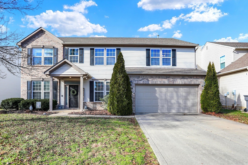 view of front of home featuring a garage and a front lawn