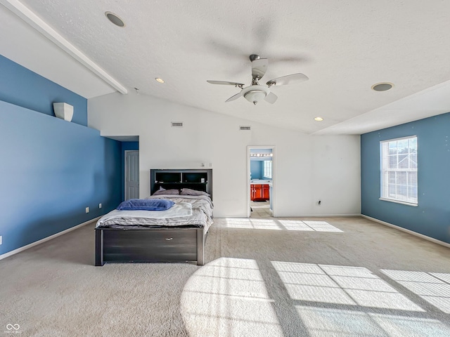 carpeted bedroom featuring lofted ceiling, ceiling fan, ensuite bath, and a textured ceiling