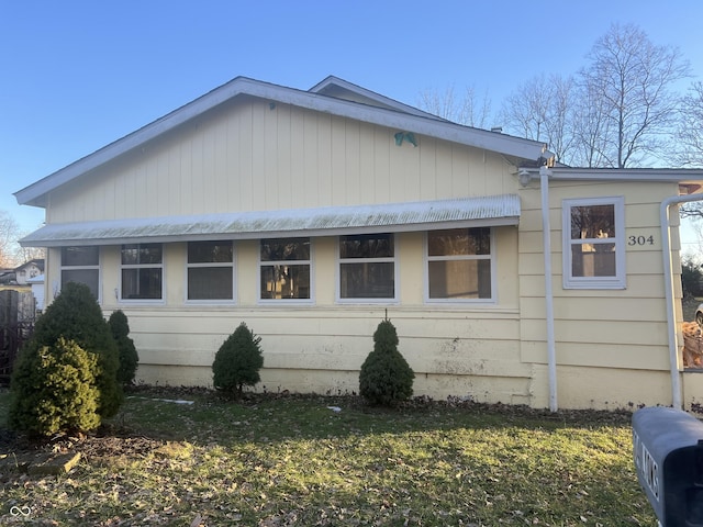 view of side of home featuring a lawn