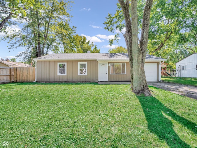 ranch-style home with a garage and a front lawn