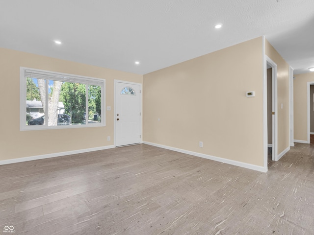 unfurnished living room featuring light wood-type flooring