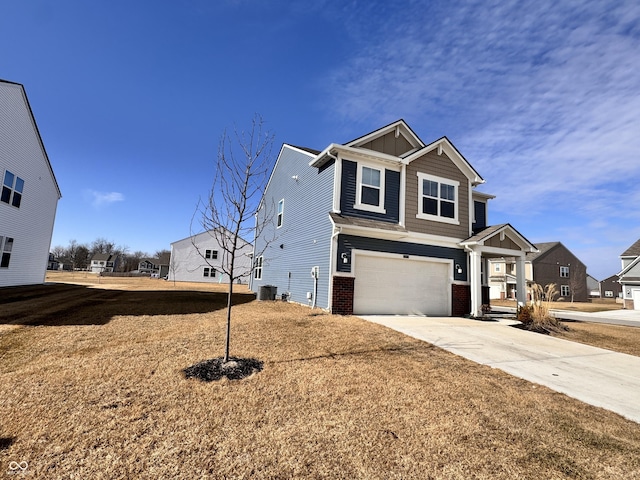 view of front of home featuring cooling unit, a garage, and a front lawn