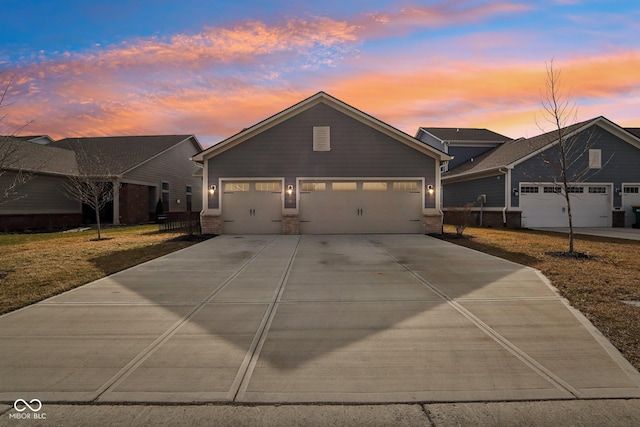 view of front of home with a garage and a lawn